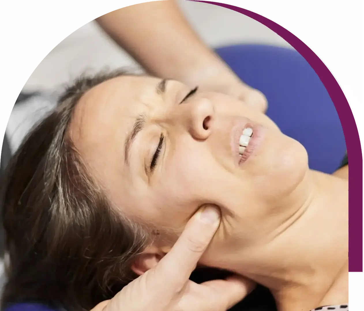 Woman receiving facial massage therapy treatment.
